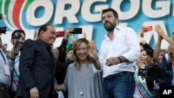 FILE - From left, Silvio Berlusconi, Giorgia Meloni and Matteo Salvini address a rally in Rome, Oct. 19, 2019. Thousands of protesters gathered in Rome for a so-called "Italian Pride" rally., 