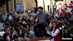 Protesters chant slogans as they march during ongoing anti-government protests in Beirut, Lebanon, Naov. 12, 2019. 