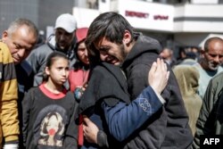 FILE — People mourn following an early morning incident when residents rushed toward aid trucks in Gaza City on February 29, 2024..