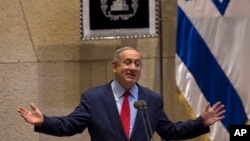 File - Israeli Prime Minister Benjamin Netanyahu, gestures during a speech at the Knesset, Oct. 31, 2016. Israel's Justice Ministry and police issued a statement Dec. 28, 2016, that said they will issue an update "in due time" about an ongoing probe into suspicions surrounding the prime minister. 