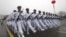 Chinese sailors march during a parade at a training base of China's North Sea Fleet (NSF) in Qingdao in east China's Shandong province on Monday, March 5, 2012. 