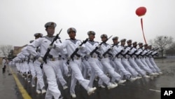 Chinese sailors march during a parade at a training base of China's North Sea Fleet in Qingdao in east China's Shandong province on Monday, March 5, 2012. 