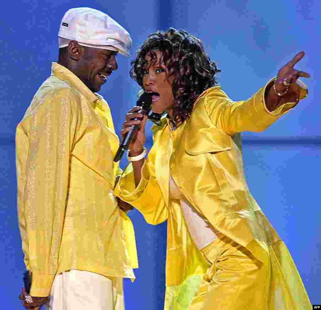 In this May 23, 2003 photo, Whitney Houston, right, and her former husband, Bobby Brown, perform in Las Vegas. Houston died at age 48 on February. 11, 2012. (AP)