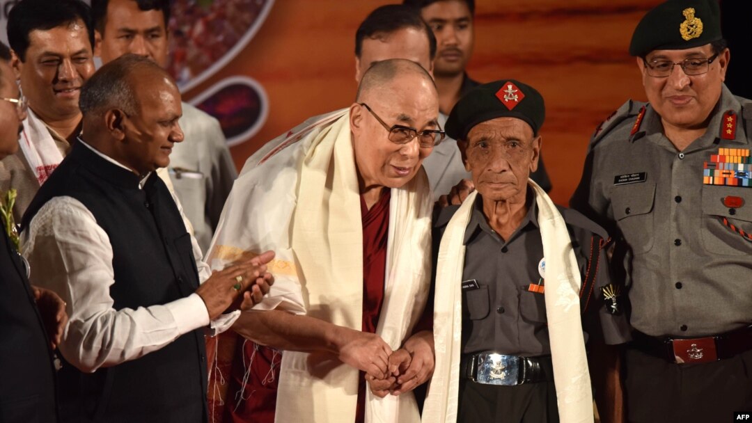 The Dalai Lama (center-left) shakes hands with Naren Chandra Das (center-right), the lone known survivor of a group of seven Indian guards who escorted the Tibetan spiritual leader into India nearly 60 years ago, in Guwahati, the capital of the northeastern Indian Assam state, April 2, 2017.