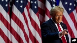 FILE - Republican presidential nominee former President Donald Trump points to the crowd at an election night watch party in West Palm Beach, Florida, Nov. 6, 2024.