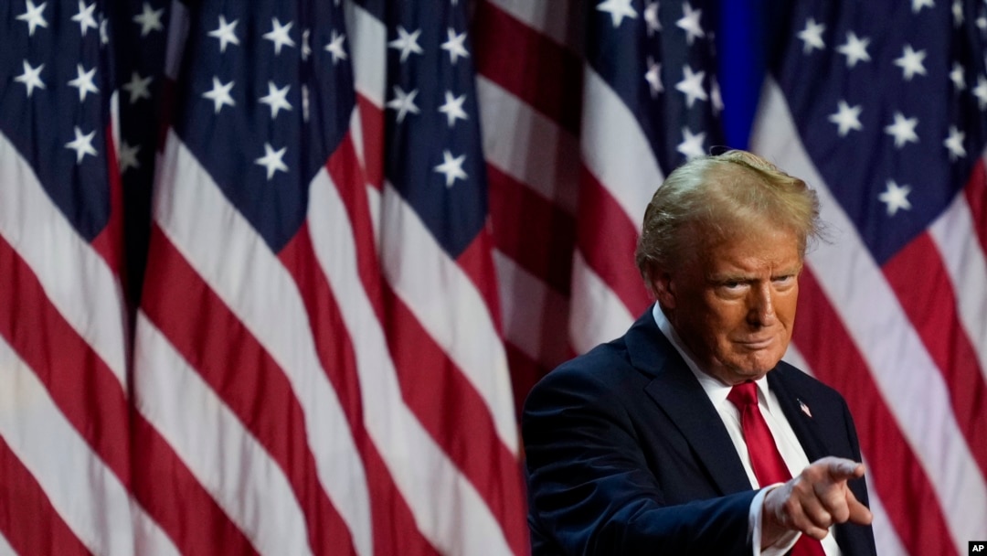 Republican presidential nominee former President Donald Trump points to the crowd at an election night watch party, Nov. 6, 2024, in West Palm Beach, Fla.