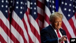 Republican presidential nominee former President Donald Trump points to the crowd at an election night watch party, Nov. 6, 2024, in West Palm Beach, Fla.