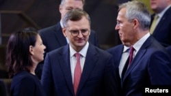 Germany's Foreign Minister Annalena Baerbock, NATO Secretary-General Jens Stoltenberg and Ukraine's Foreign Minister Dmytro Kuleba attend a meeting of the NATO-Ukraine Council together with Sweden at the Alliance's headquarters in Brussels, Nov. 29, 2023. 