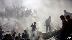 Palestinians inspect the rubble of destroyed buildings following Israeli airstrikes on the town of Khan Younis, southern Gaza Strip, Thursday, Oct. 26, 2023.