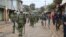 Kenyan police officers walk toward protesters in Nairobi’s Kibera slum, Aug. 12, 2017. Protests broke out following an announcement the previous night that President Uhuru Kenyatta had been re-elected. (J. Craig/VOA)