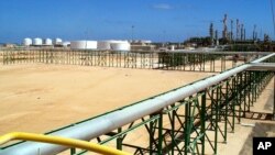 FILE - A gas compression plant is seen on the shore of Mellitah, Libya.