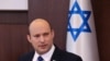 Israeli Prime Minister Naftali Bennett chairs the first weekly cabinet meeting of the new government in Jerusalem, Sunday, June 20, 2021. Bennett opened his first Cabinet meeting with a condemnation of the newly elected Iranian president, whom he…