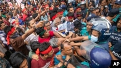 Activists clash with the police as they stage a song march to remember victims of the recent countrywide deadly clashes, in Dhaka, Bangladesh, July 30, 2024.