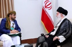 FILE - Iranian Supreme Leader Ayatollah Ali Khamenei, right, listens to Mohammed Abdul-Salam, spokesman for the Yemen Houthi rebels, at the Iranian leader's residence, Aug. 13, 2019.