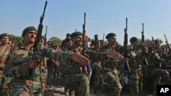 FILE - Indian army soldiers pay tribute to their colleague Rajat Kumar Basan, during his funeral at village Pallanwala in Akhnoor sector, about 85 kilometers (53 miles) north of Jammu, India, Oct.22, 2018. 