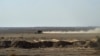 FILE - Afghan migrants ride in a pickup truck along a desert road toward the Iran border, Feb. 17, 2022. Dozens of Afghans were reportedly killed by Iranian forces while illegally crossing the border from Pakistan, a Taliban official said Oct. 16, 2024.