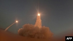 This screen grab taken on July 15, 2026, from video footage released by Iran's Revolutionary Guards (IRGC)'s Sepah News website on July 14, 2026, allegedly shows missiles being launched from an undisclosed location towards US targets in Bahrain and Kuwait