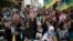 Thousands of Moroccans wave Berber flags and hold photos of detained activists as they take part in a demonstration in Rabat, Morocco, Sunday, April 21, 2019. 