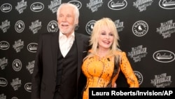 Kenny Rogers and Dolly Parton walk the red carpet of the "All In For The Gambler: Kenny Rogers' Farewell Concert Celebration" at Bridgestone Arena on Oct. 25, 2017, in Nashville, Tenn. 