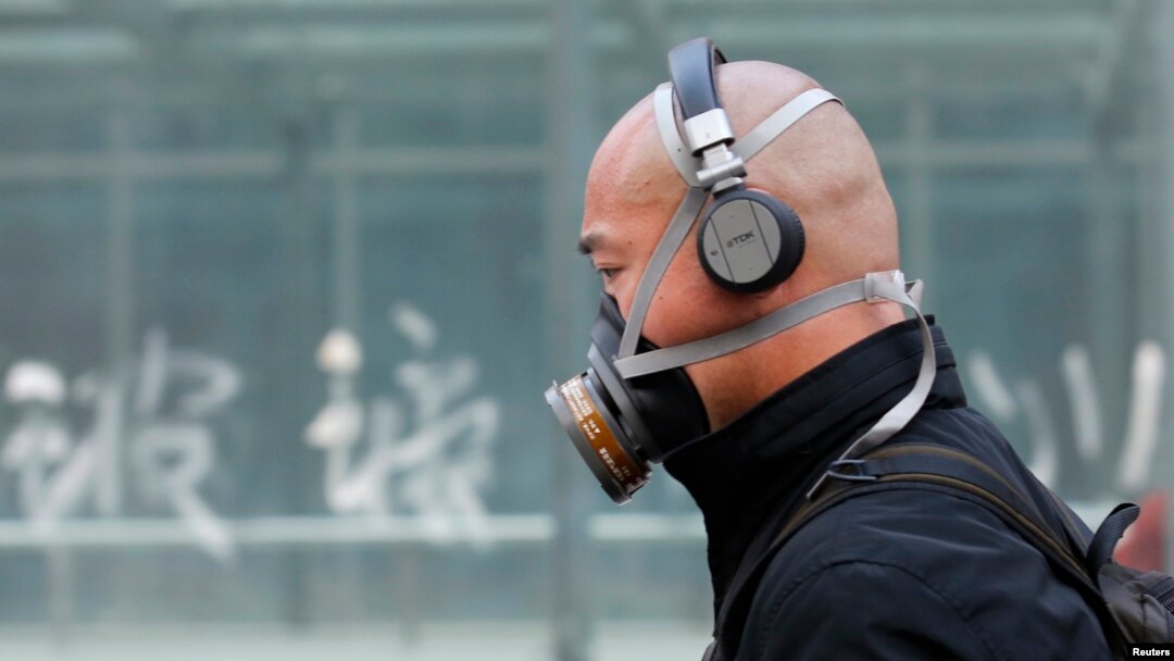 A man wearing a mask is seen on a street in Beijing, May 2, 2013.