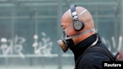 A man wearing a mask is seen on a street in Beijing, May 2, 2013.