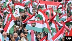 Supporters of the opposition 'TISZA' party protest against what they call "government propaganda" at the main state MTVA channel headquarters in Budapest, Hungary, Oct. 5, 2024.