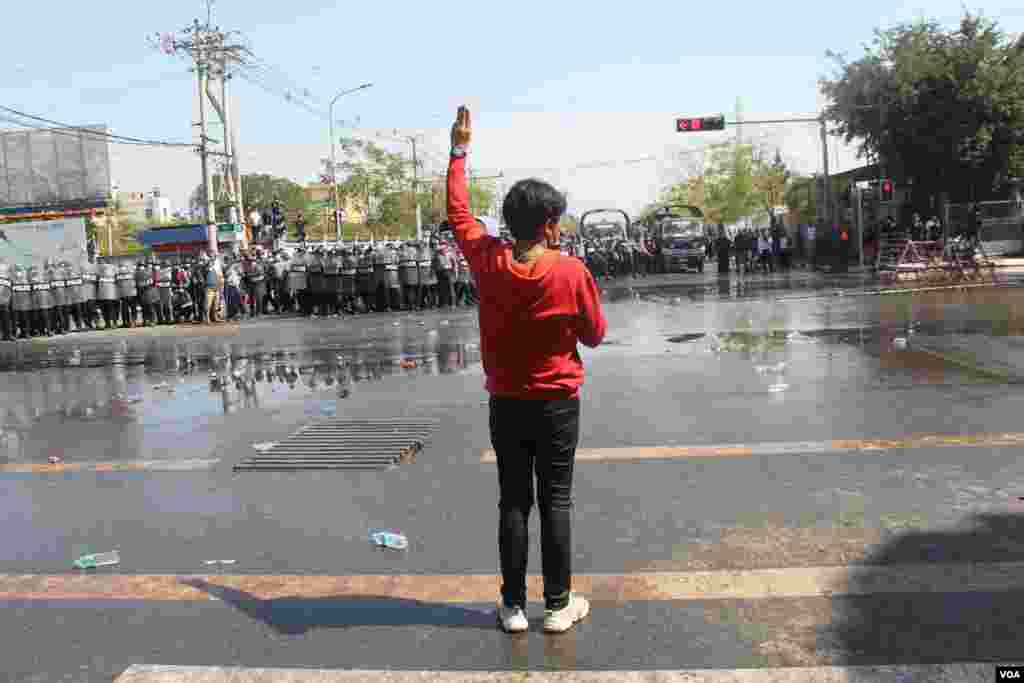 A protester flashes the three-finger salute during a protest against the military coup in Mandalay, Myanmar, Feb. 9, 2021. (Credit: VOA Burmese Service)