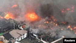 A fire engulfs houses and stores, near JR Itoigawa Station, in Itoigawa, Niigata Prefecture, Japan, in this photo taken by Kyodo, Dec. 22, 2016.