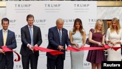 (L-R) Donald Trump Jr., Eric Trump, then-Republican U.S. presidential nominee Donald Trump, Melania Trump, Tiffany Trump and Ivanka Trump attend an official ribbon cutting ceremony at the new Trump International Hotel in Washington, D.C., Oct. 26, 2016.