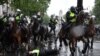 A mounted police officer is seen on the ground after being unseated from his horse, during a demonstration on Whitehall, near the entrance to Downing Street in central London, June 6, 2020, to show solidarity with the Black Lives Matter movement in the wake of the death of George Floyd who died in Minneapolis police custody.&nbsp;