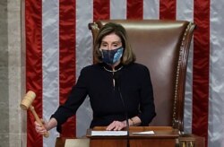 FILE - U.S. House Speaker Nancy Pelosi, D-Calif., presides over the vote to impeach President Donald Trump for a second time, a week after his supporters stormed the Capitol, on the House floor in Washington, Jan. 13, 2021.