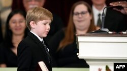 FILE - Great grandchild Charles Jeffrey Carter walks with a Bible to read a scripture during the funeral service for former first lady Rosalynn Carter at Maranatha Baptist Church in Plains, Georgia, on November 29, 2023.