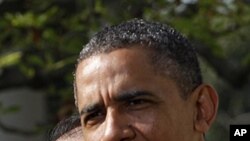 U.S. President Barack Obama (R) introduces Dartmouth College President Jim Yong Kim as his nominee to be the next president of the World Bank, in the Rose Garden of the White House in Washington, March 23, 2012. 