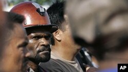 Freeport McMoRan Copper & Gold Inc.'s workers await bus at Gorong Gorong station in Timika, Papua province, Indonesia, Jan. 3, 2012.