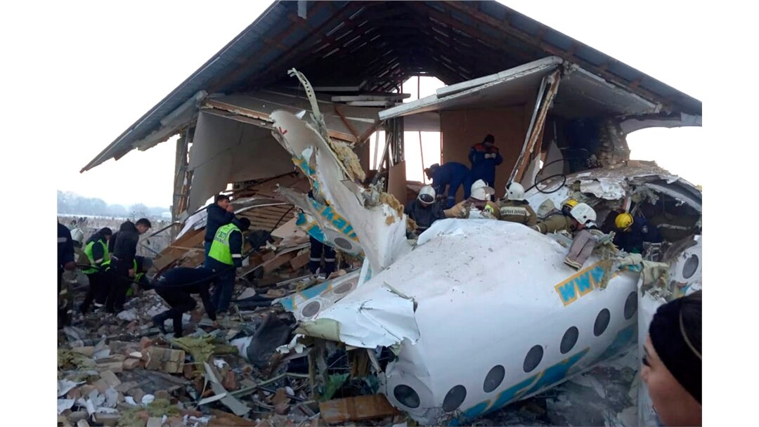 In this handout photo provided by the Emergency Situations Ministry of the Republic of Kazakhstan, police and rescuers work on the side of a plane crash near Almaty International Airport, outside Almaty, Kazakhstan, Dec. 27, 2019.