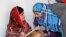 Pakistani teenage activist Malala Yousafzai (L), who was shot in the head by the Taliban for campaigning for girls' education, talks to Syrian refugee Mazoon Rakan, 16, about Mazoon's experience in the camp during her visit to the Zaatri refugee camp, in 