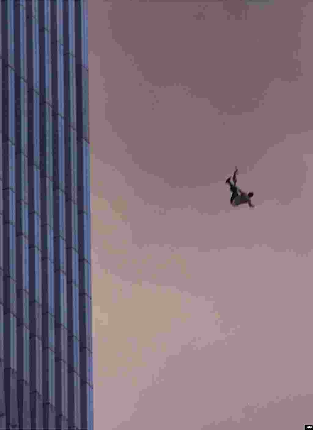 A person falls to his death from the World Trade Center after two planes hit the Twin Towers in New York City.