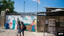 FILE - A man and woman leave a Doctors Without Borders clinic after finding the clinic closed in Port-au-Prince, Haiti, on Nov. 20, 2024. The organization announced on Dec. 11, 2024, that it would partially resume its work in Port-au-Prince.