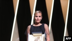 FILE - French director Julia Ducournau has won the Palme d'Or for her film "titanium" at the 74th Cannes Film Festival in Cannes, France, July 17, 2021.