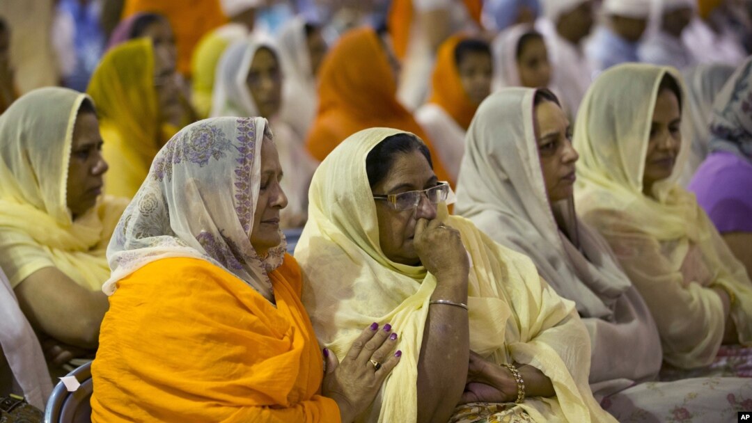 Mourners attend the funeral and memorial service for the six victims of the Sikh temple of Wisconsin mass shooting in Oak Creek, Wisconsin, Friday, Aug 10, 2012. 