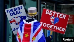 FILE - Anti-Brexit protester Steve Bray demonstrates outside the conference center where earlier Brexit trade deal negotiations were taking place, in London, Nov. 9, 2020. 