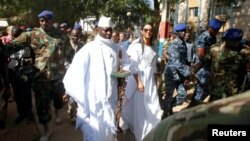 FILE - Gambian President Yahya Jammeh arrives at a polling station with his wife Zineb during presidential elections in Banjul, Gambia, Dec. 1, 2016. Jammeh has been demanding that the poll results be nullified.