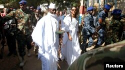 FILE - Gambian President Yahya Jammeh arrives at a polling station with his wife, Zineb, during the presidential election in Banjul, Gambia, Dec. 1, 2016.