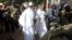 FILE - Gambian President Yahya Jammeh arrives at a polling station with his wife, Zineb, during the presidential election in Banjul, Gambia, Dec. 1, 2016.