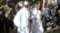 Gambian President Yahya Jammeh arrives at a polling station with his wife, Zineb, during the presidential election in Banjul, Gambia, Dec. 1, 2016.