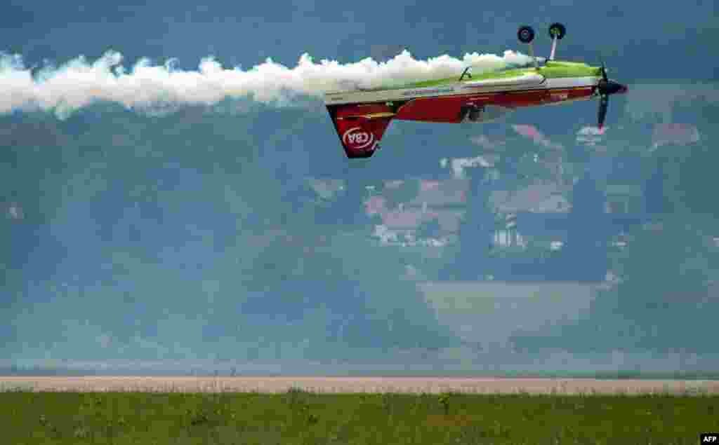 Legendary acrobatic pilot Zoltan Veres of Hungary on his MXS aircraft demonstrates his skills with his F-16 at the Slovak International Air Fest SIAF 2014 at the Slovak Airforce Base of Sliac, Aug. 30, 2014.