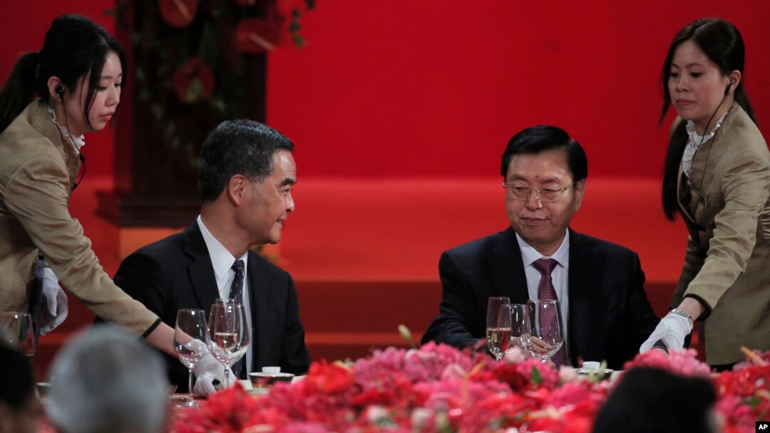 Hong Kong Chief Executive Leung Chun-ying, left, looks at Zhang Dejiang, right, chairman of China's National People's Congress, during a banquet in Hong Kong, Wednesday, May 18, 2016.