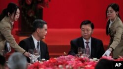 Hong Kong Chief Executive Leung Chun-ying, left, looks at Zhang Dejiang, right, chairman of China's National People's Congress, during a banquet in Hong Kong, Wednesday, May 18, 2016.