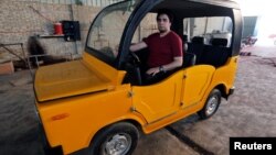 Ahmed Saeed Omar, 35, looks on inside his new "Mini-Car-Egypt" car at his workshop, near Egypt's pyramids of Giza, in Kerdasa, Egypt, May 10, 2017. 
