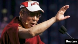 Tibetan spiritual leader the Dalai Lama speaks while wearing his University of Maryland visor at the Anwar Sadat Lecture for Peace at the University of Maryland in College Park, Maryland, May 7, 2013. 